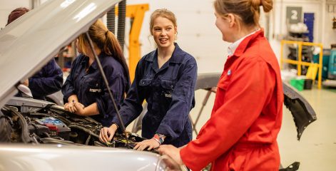 Group of Automotive students looking at an engine