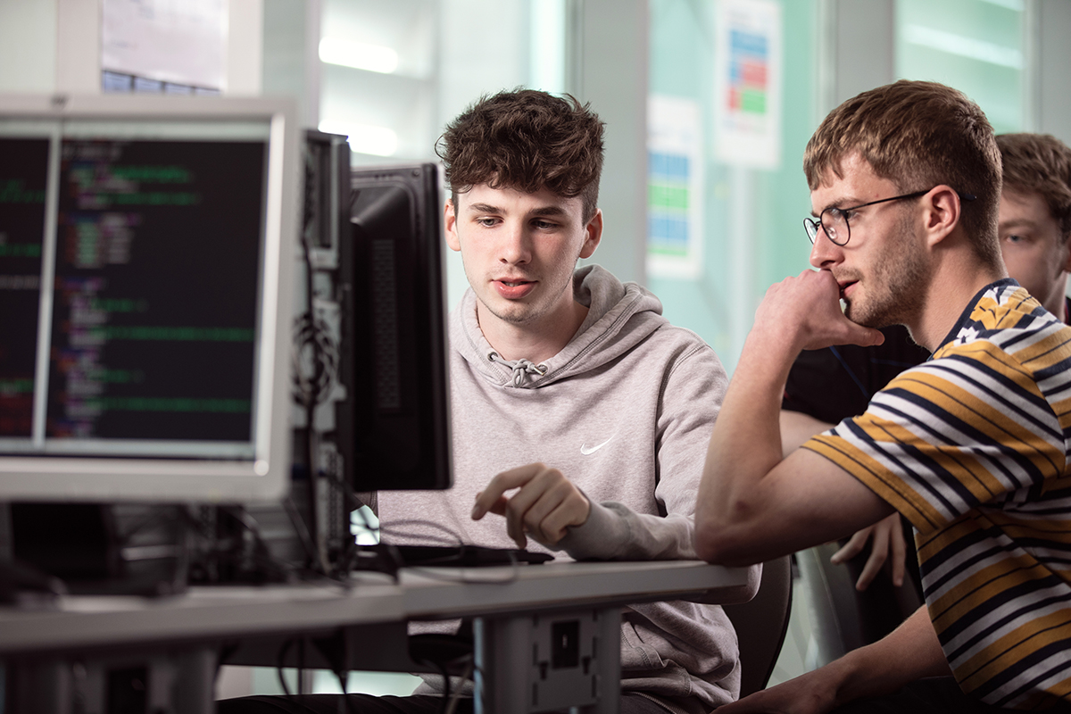 Digital technology students working on a computer