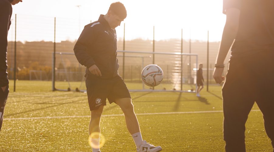 Football Academy student kicking ball