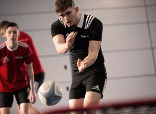 Men's Rugby players throwing ball