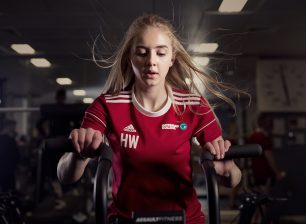 Student working out on exercise bike