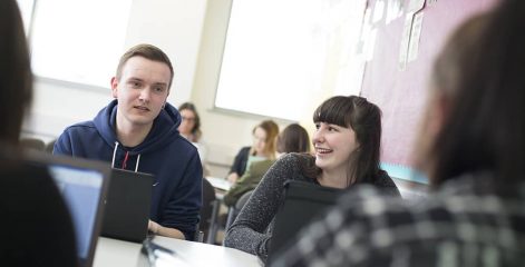 Students sat at tables in a classroom