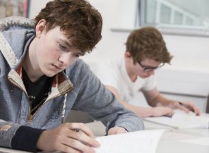 Students working at a desk in classroom