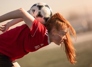 Women's football player practicing