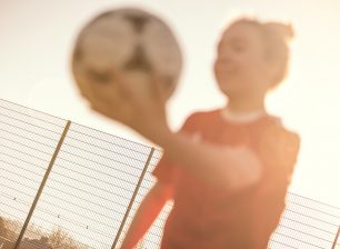 Women's football player with ball
