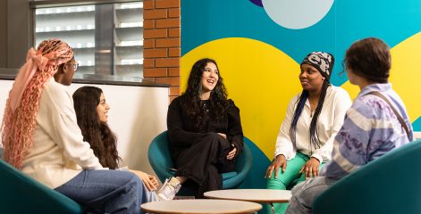 Group of ESOL students sat together laughing