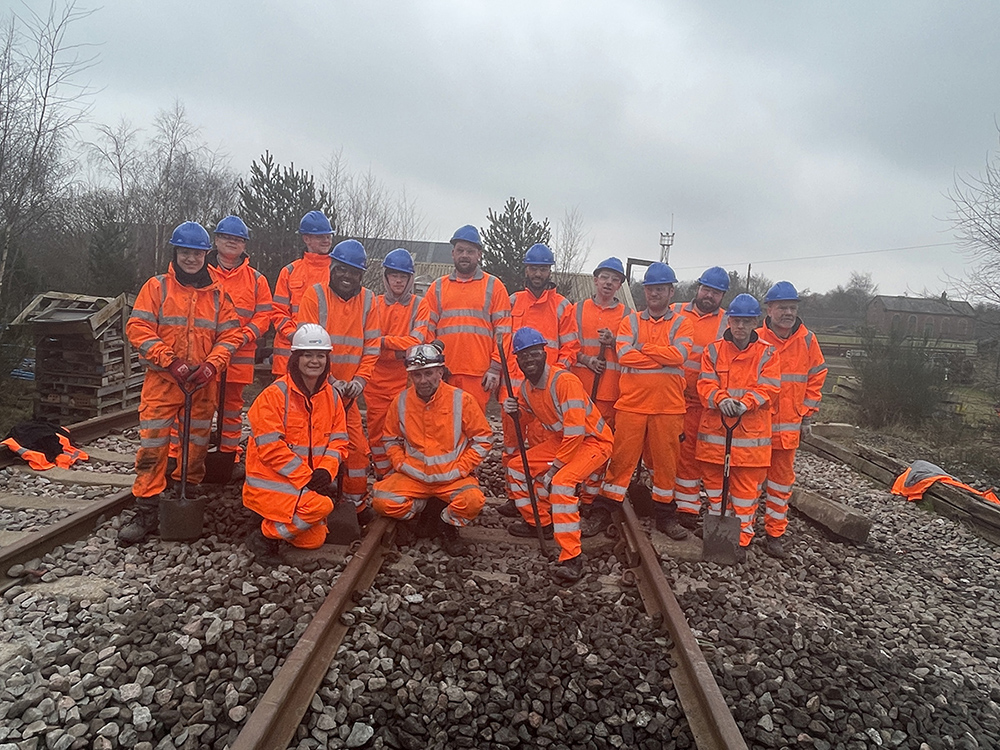 Large ground of rail students in orange high vis jackets