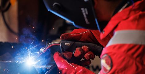 Person in full protective wear welding