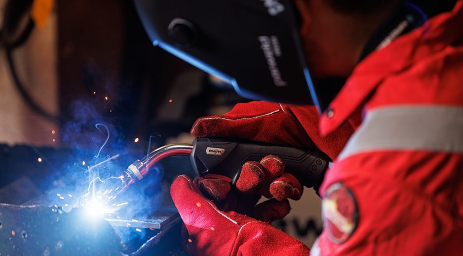 Person in full protective wear welding