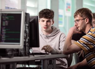 Two digital technology students working together on a computer