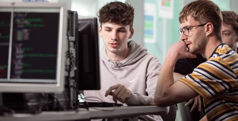 Two digital technology students working together on a computer