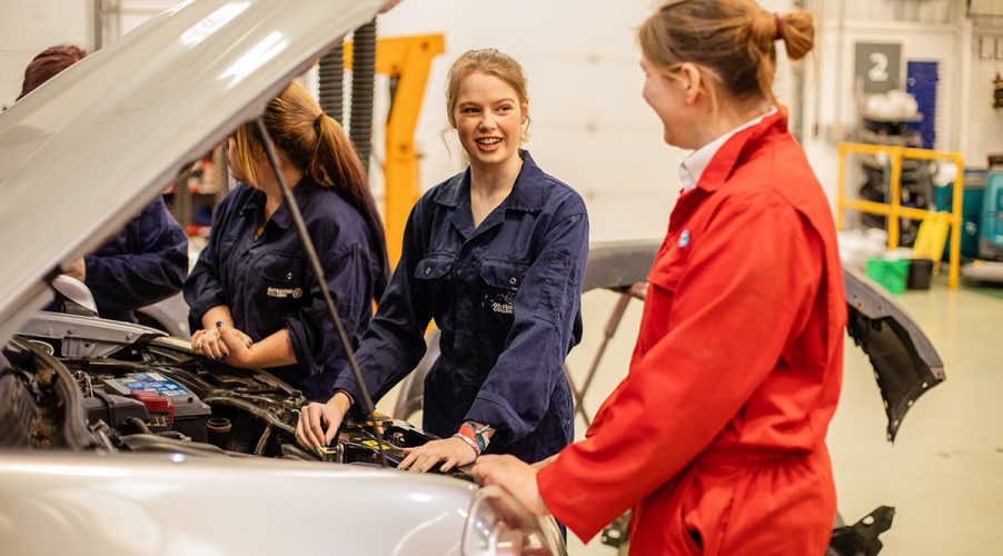 Group of Automotive students looking at an engine