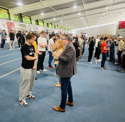 Groups of students and employers talking