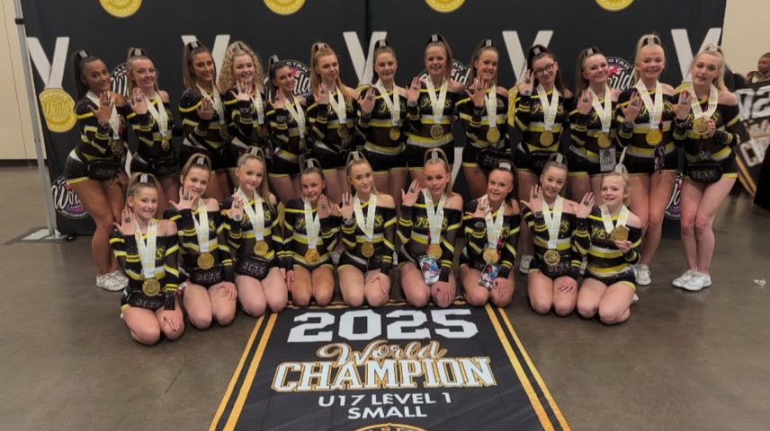 A cheerleading team posing with a banner saying '2025 World Champions'