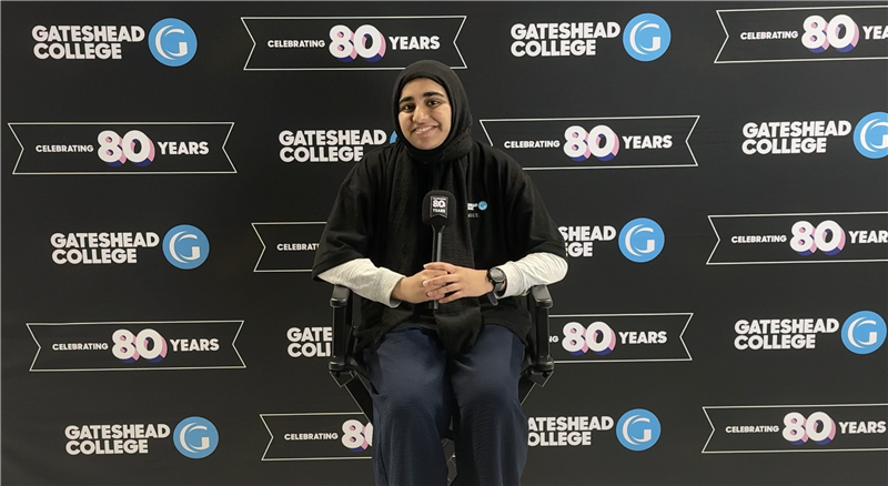 A young lady sitting in a set for Gateshead College