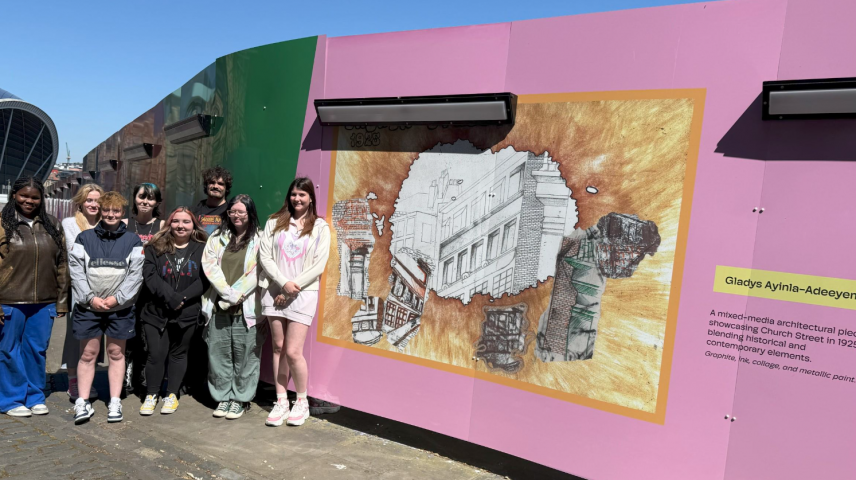a group of students standing outside with outdoor displays of their art.