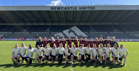 A women's football team on the football pitch at St James' Park