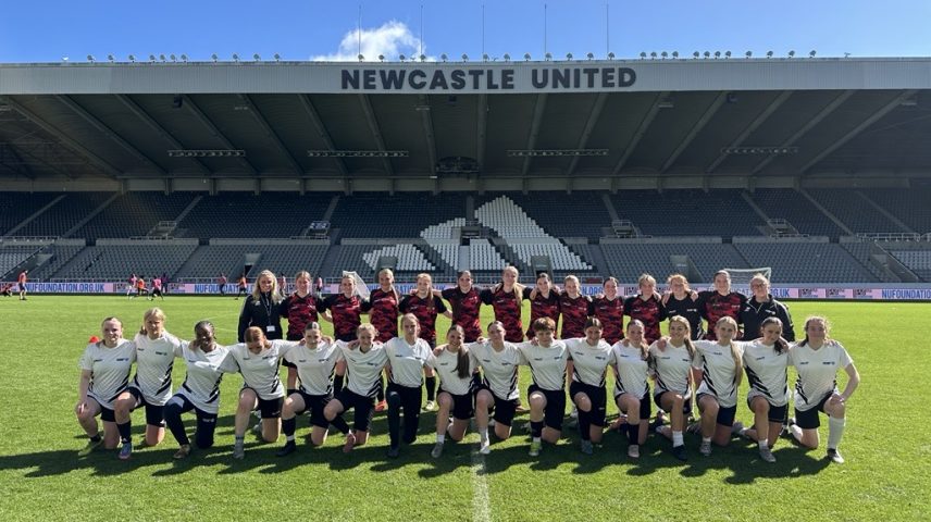 A women's football team on the football pitch at St James' Park