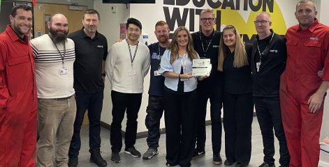 a group of men and women holding an award