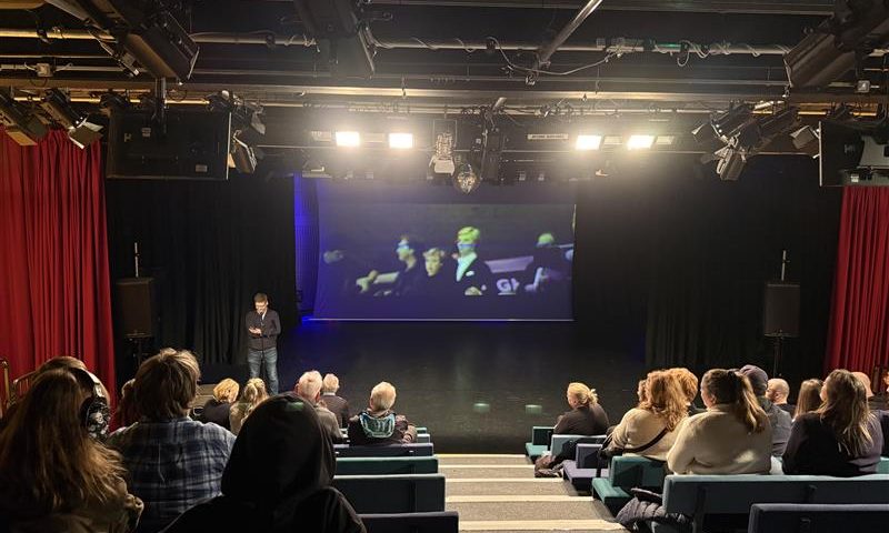 A group of people watching a film in a theatre