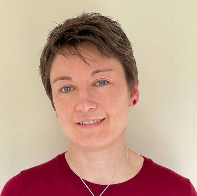 Jennifer Boyle, smiling to camera wearing red top