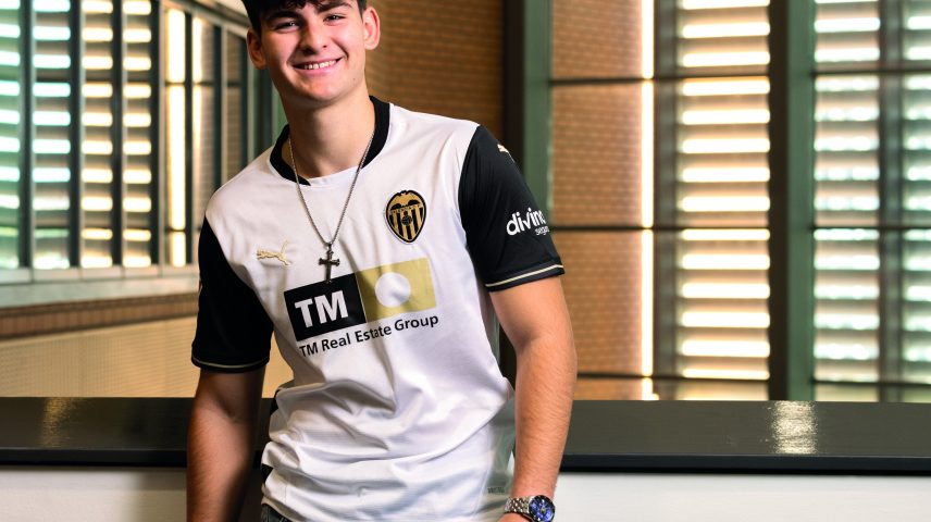 A student standing smiling.