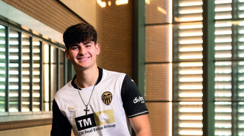 A student standing smiling.