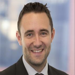 Ryan - wearing suit, smiling to camera