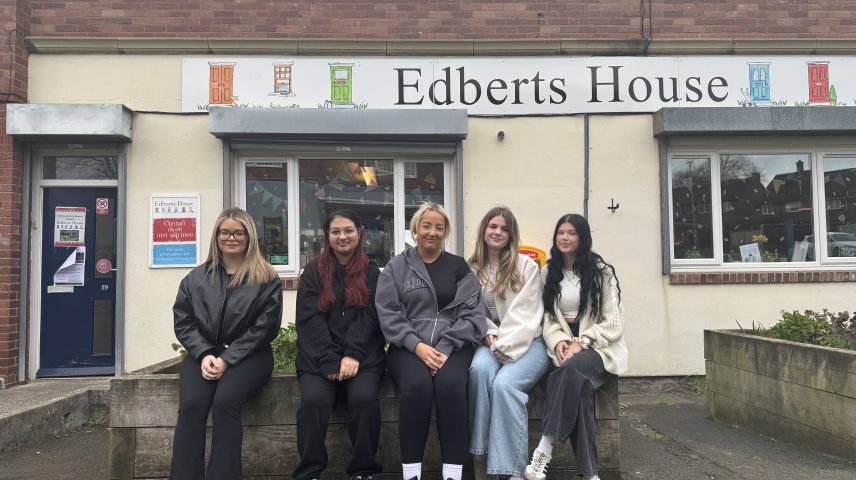 A group of Gateshead College students sat outside a building called 'Edberts House'