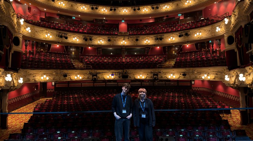 Two students standing on a theatre stage